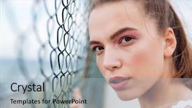  Presentation with chain link fence - PPT layouts having closeup of beautiful young woman standing near chain link fence background and a light blue colored foreground