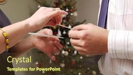  Presentation with wafer - Presentation theme having closeup of young couple hands sharing traditional christmas eve wafer with christmas tree in the background background and a tawny brown colored foreground