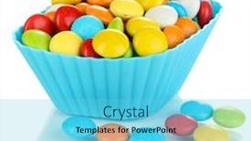  Presentation with cupcake - Colorful presentation theme enhanced with colorful candies in cupcake case isolated on white backdrop and a light blue colored foreground