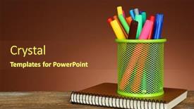  Presentation with green notebook - Colorful slide deck enhanced with colorful markers in green metal holder with notebook on wooden table and shaded color background backdrop and a tawny brown colored foreground