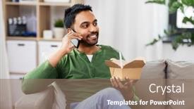  Presentation with indian food - Presentation theme consisting of communication leisure and people concept - smiling indian man calling on smartphone and eating takeaway food at home background and a coral colored foreground