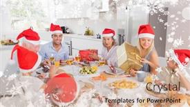  Presentation with christmas dinner - Theme featuring composite image of a smiling family around the dinner table at christmas against snow background and a coral colored foreground
