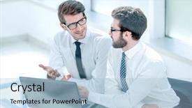  Presentation with laptop - Slide set having coordination meeting - two business colleagues looking background and a light blue colored foreground