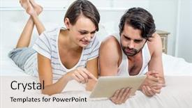  Presentation with using digital tablet - Amazing PPT theme having couple using digital tablet while lying on bed at home backdrop and a coral colored foreground