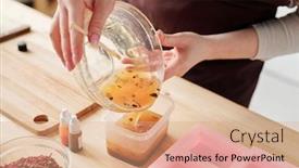  Presentation with plastic container - Theme having craftswoman pouring liquid soap mass with orange essence and grated spices from large glass bowl into smaller plastic container background and a coral colored foreground