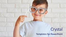  Presentation with white brick wall - PPT theme consisting of curious and joyful boy holding paper glasses on a stick posing against white brick wall background and a sky blue colored foreground