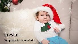  Presentation with baby christmas - PPT theme featuring cute baby boy on couch at christmas against hanging snowflakes background and a soft green colored foreground