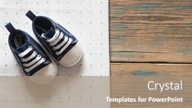  Presentation with baby shoes - Amazing PPT theme having cute little baby shoes on green polka dot background top view backdrop and a coral colored foreground