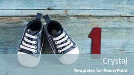  Presentation with baby shoes - Slide set having cute little baby shoes on wood background top view background and a light blue colored foreground