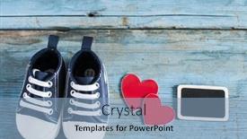  Presentation with baby shoes - Slides with cute little baby shoes on wood background top view background and a light blue colored foreground