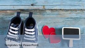  Presentation with baby shoes - Cool new presentation theme with cute little baby shoes on wood background top view backdrop and a seafoam green colored foreground