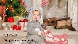  Presentation with baby christmas - Amazing PPT theme having cute little baby wearing bunny suit in room decorated for christmas backdrop and a coral colored foreground