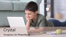  Presentation with young man holdng laptop on lap money - PPT theme enhanced with cute little boy using laptop background and a mint green colored foreground