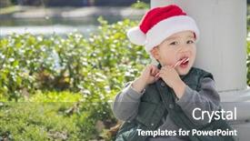  Presentation with cane - Colorful PPT theme enhanced with cute mixed race boy sitting wearing christmas santa hat and enjoying a candy cane backdrop and a dark gray colored foreground