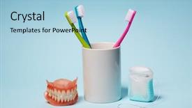  Presentation with dentures - PPT theme consisting of dental equipment colorful toothbrushes dentures background and a light blue colored foreground