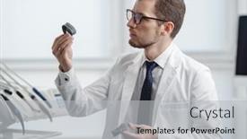  Presentation with jaw - PPT theme consisting of dentist-looking-at-photopolymer-jaw background and a light gray colored foreground