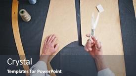  Presentation with patterns - Theme consisting of directly above shot of tailor working at table in atelier studio cutting patterns background and a tawny brown colored foreground