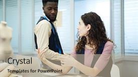  Presentation with ethnic - Presentation theme with dressmaking - serious young multi-ethnic dressmakers discussing background and a mint green colored foreground