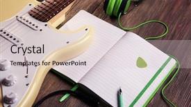  Presentation with note book - PPT layouts featuring electric guitar with green headphones and note book on wooden background background and a light gray colored foreground
