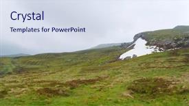  Presentation with green grass under the snow - Audience pleasing theme consisting of green landscape with eternal snow backdrop and a sky blue colored foreground