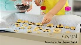  Presentation with sprinkles - Theme featuring family cooking and baking concept - mother and little daughter with chocolate sprinkles decorating cookies on tray at home kitchen background and a coral colored foreground