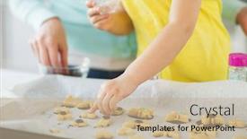  Presentation with sprinkles - Presentation theme with family cooking and baking concept - mother and little daughter with sprinkles decorating cookies on tray at home kitchen background and a mint green colored foreground