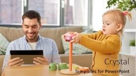  Presentation with baby toy - Presentation theme having family fatherhood and people concept - happy father with tablet pc computer and little baby daughter playing with pyramid toy at home background and a yellow colored foreground