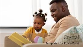  Presentation with baby book - Presentation theme with family fatherhood and people concept - happy african american father reading book for baby daughter at home background and a coral colored foreground