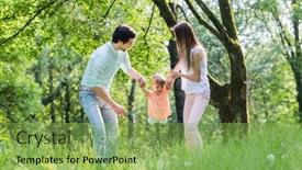  Presentation with family holding hands - PPT theme featuring family having walk together in summer holding hands and letting the little boy fly background and a seafoam green colored foreground