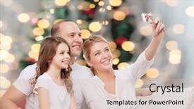  Presentation with family tree - Beautiful theme featuring family holidays technology and people concept - smiling mother father and little girl making selfie with camera over christmas tree lights background backdrop and a soft green colored foreground