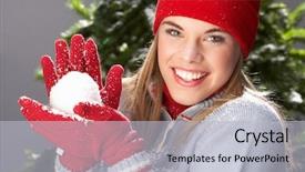  Presentation with snowball - Theme featuring fashionable teenage girl wearing cap and knitwear holding snowball in studio in front of christmas tree background and a light gray colored foreground