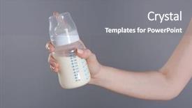  Presentation with baby bottle - Audience pleasing PPT theme consisting of feed supplement - female hand holding a baby backdrop and a gray colored foreground