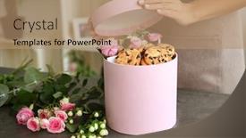  Presentation with box - Colorful slides enhanced with female florist preparing box with beautiful flowers and cookies closeup backdrop and a coral colored foreground