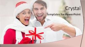  Presentation with christmas tree - Beautiful presentation theme featuring festive young couple holding gift against blurry christmas tree in room backdrop and a soft green colored foreground