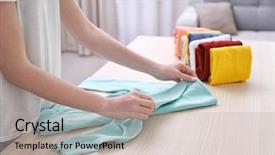  Presentation with clothes - Slides with folded - woman folding clothes on table background and a mint green colored foreground