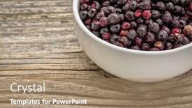  Presentation with freeze - Audience pleasing presentation theme consisting of freeze dried elderberries in white ceramic bowl against grained wood backdrop and a coral colored foreground