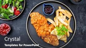  Presentation with veal - Slide deck having fried wiener schnitzel from veal topside with french fries and lettuce as top view on a modern design plate background and a dark gray colored foreground