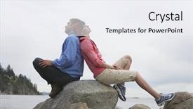  Presentation with rocks - Theme enhanced with full length side view of a young couple sitting back to back on rocks against ocean background and a sky blue colored foreground