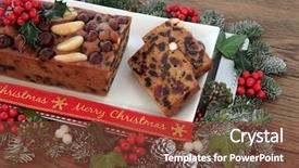  Presentation with christmas holly - Audience pleasing presentation theme consisting of genoa cake and slices with merry christmas ribbon with holly mistletoe and winter greenery over oak background backdrop and a tawny brown colored foreground