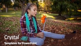  Presentation with pinwheel - PPT layouts consisting of girl blowing pinwheel while sitting in park during autumn background and a tawny brown colored foreground