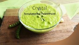  Presentation with green glass - Cool new presentation with green pea soup in glass bowl on wooden cutting board closeup backdrop and a yellow colored foreground
