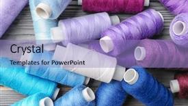  Presentation with sewing process close up - Colorful presentation enhanced with grey shaded color - colorful sewing threads on wooden backdrop and a light blue colored foreground
