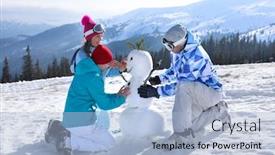  Presentation with snowman - PPT theme with group of friends making snowman at ski resort winter vacation background and a light blue colored foreground