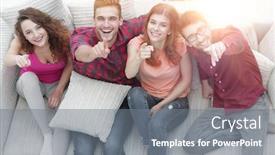  Presentation with forefinger - PPT theme consisting of group of laughing friends sitting on sofa and showing forefinger on the camera background and a gray colored foreground
