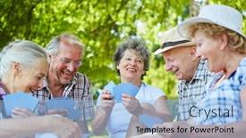  Presentation with playing cards - Presentation theme with group of seniors friends playing cards in the park in summer on a meadow background and a light blue colored foreground