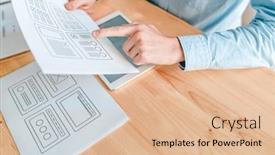  Presentation with software - Slide set featuring hand of young interface designer pointing at program interface on one of papers while working over new software background and a lemonade colored foreground