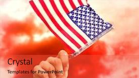  Presentation with american flag waving - Colorful presentation design enhanced with hand waving american flag against green grass under red cloudy sky backdrop and a red colored foreground