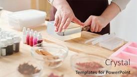  Presentation with mass - Presentation with hands of craftswoman with knife cutting piece from large bar of hard soap mass on wooden board while working in studio background and a lemonade colored foreground