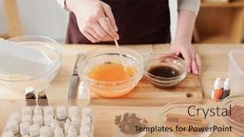  Presentation with wooden stick - Beautiful presentation featuring hands of young craftswoman mixing liquid soap mass with orange essential oil in bowl with wooden stick backdrop and a coral colored foreground