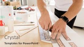  Presentation with smartwatch - Beautiful slide deck featuring hands of young creative man with smartwatch cutting one of decor samples with stainless knife while bending over wooden table backdrop and a lemonade colored foreground